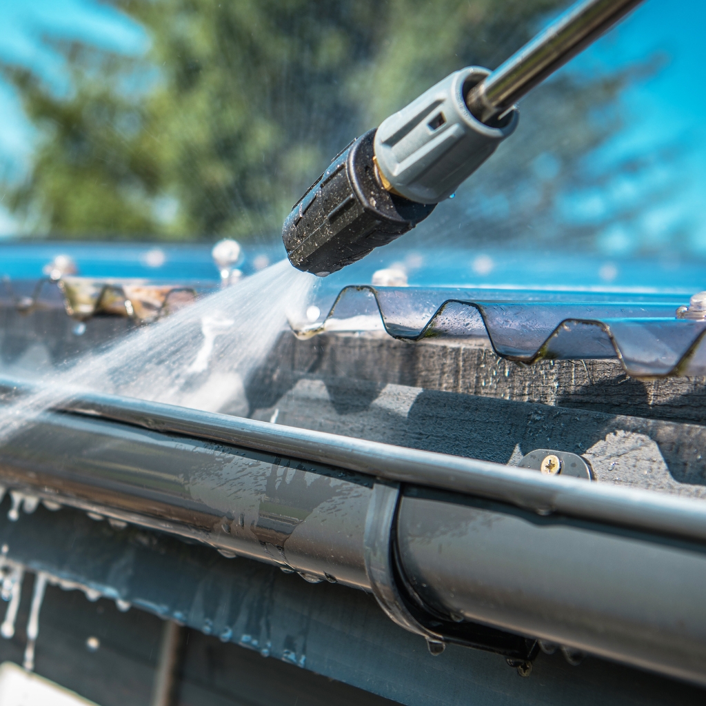 Cleaning gutter with pressure washer